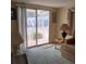 Living room area with sliding door access to the outside, and neutral carpet at 718 S Green Cir, Venice, FL 34285