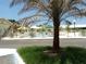 Community pool area with lush landscaping and a charming white fence at 718 S Green Cir, Venice, FL 34285