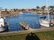A waterfront community with beautiful docks and boat slips on a sunny day at 718 S Green Cir, Venice, FL 34285
