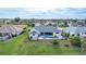 Aerial view of a single-Gathering home featuring a screened lanai, swimming pool, and well-maintained lawn at 8 Bunker Ln, Rotonda West, FL 33947