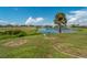 Backyard with a beautiful lake view and lush green grass at 8 Bunker Ln, Rotonda West, FL 33947