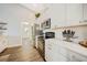 View of the kitchen, with a focus on the oven and range, as well as the white cabinets at 8 Bunker Ln, Rotonda West, FL 33947