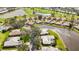 An aerial view of a home, pond, and golf course in a residential community at 803 Carnoustie Dr, Venice, FL 34293