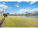 Beautiful backyard landscape with a peaceful water view, creating a serene outdoor retreat at 803 Carnoustie Dr, Venice, FL 34293