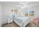 Comfortable bedroom with a large bed, ceiling fan, and window with view to the outdoors at 803 Carnoustie Dr, Venice, FL 34293