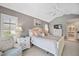 Bright bedroom with vaulted ceilings, large bed, and a sliding glass door provides natural light at 803 Carnoustie Dr, Venice, FL 34293