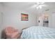 Relaxing bedroom featuring a large bed, ceiling fan, and a quaint chair at 803 Carnoustie Dr, Venice, FL 34293