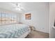Relaxing bedroom with a large bed, ceiling fan, and window with view to the outdoors at 803 Carnoustie Dr, Venice, FL 34293