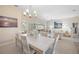 Open-concept view of the dining area leading into the living room, creating a seamless flow at 803 Carnoustie Dr, Venice, FL 34293
