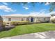 Beautifully landscaped front yard complements this lovely single-story home with a crisp white roof at 803 Carnoustie Dr, Venice, FL 34293