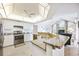 Well-lit kitchen features granite countertops, white cabinets, and stainless steel appliances at 803 Carnoustie Dr, Venice, FL 34293