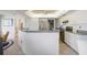 Open kitchen includes a granite countertop, white cabinetry, and stainless steel appliances at 803 Carnoustie Dr, Venice, FL 34293