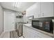 Well-organized laundry room with modern appliances, granite countertops, and ample storage at 803 Carnoustie Dr, Venice, FL 34293