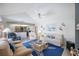 The spacious living room connects to the open kitchen and features vaulted ceilings and comfortable seating at 803 Carnoustie Dr, Venice, FL 34293