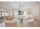 Comfortable living area showcases plush seating, glass tables, and a large sliding glass door to the lanai at 803 Carnoustie Dr, Venice, FL 34293
