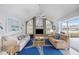 Bright living room with vaulted ceiling, TV, two sofas, and sliding doors to the outside patio at 803 Carnoustie Dr, Venice, FL 34293
