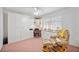Bright home office featuring built-in cabinets, desk space, and comfortable seating area at 803 Carnoustie Dr, Venice, FL 34293
