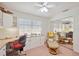 Cozy home office with built-in cabinets, desk, mirror closet door, and comfortable chair at 803 Carnoustie Dr, Venice, FL 34293