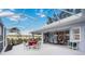 Expansive screened patio with multiple seating areas for entertaining and enjoying the water view at 803 Carnoustie Dr, Venice, FL 34293