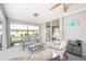 Relaxing screened-in patio featuring a comfortable seating area and serene backyard view at 803 Carnoustie Dr, Venice, FL 34293