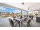 Enclosed patio with a spacious seating and dining area overlooking the outdoors at 803 Carnoustie Dr, Venice, FL 34293