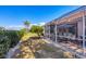 Beautiful backyard showcasing a screened lanai, well-maintained lawn, and mature trees, ideal for outdoor living and entertaining at 805 Derbyshire Dr, Venice, FL 34285