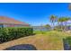 Beautiful backyard with palm trees and serene lake view enhances this home at 805 Derbyshire Dr, Venice, FL 34285