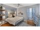 Inviting bedroom showcases hardwood floors, a comfortable bed, and ample natural light through a window at 805 Derbyshire Dr, Venice, FL 34285