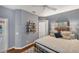 Comfortable bedroom with industrial shelves, hard wood floors, and simple decor at 805 Derbyshire Dr, Venice, FL 34285