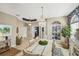 Charming dining area with a chandelier, patterned wallpaper, and view to the entry at 805 Derbyshire Dr, Venice, FL 34285