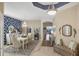 Beautiful dining room featuring an elegant chandelier, statement wall and view of outdoor patio at 805 Derbyshire Dr, Venice, FL 34285
