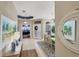 Inviting foyer and dining room area with stylish decor, a decorative mirror, and chandelier lighting at 805 Derbyshire Dr, Venice, FL 34285