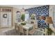 Elegant dining room with a chandelier, large windows, and stylish wallpaper at 805 Derbyshire Dr, Venice, FL 34285