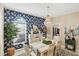 Dining room featuring a statement wall, decorative chandelier and stylish furnishings at 805 Derbyshire Dr, Venice, FL 34285