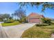 Attractive single-story home with a tile roof and a paved driveway at 805 Derbyshire Dr, Venice, FL 34285