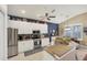 Bright kitchen featuring stainless steel appliances, granite countertops, and ample cabinet space at 805 Derbyshire Dr, Venice, FL 34285