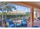 Inviting screened lanai with comfortable seating, dining space, and a lush backyard view, creating a relaxing outdoor oasis at 805 Derbyshire Dr, Venice, FL 34285