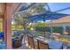 Well-appointed screened lanai with outdoor dining and lounge areas, perfect for enjoying the beautiful surrounding landscape at 805 Derbyshire Dr, Venice, FL 34285