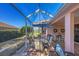 Charming screened lanai featuring outdoor dining and lounge areas, providing a delightful space to enjoy the serene setting at 805 Derbyshire Dr, Venice, FL 34285