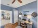 Bright office space boasts hardwood floors, a cozy desk, and an open doorway to the living area at 805 Derbyshire Dr, Venice, FL 34285