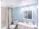 Bathroom featuring a single vanity sink, toilet, and a shower-tub combo with a blue color theme at 811 Waterside Dr # 102, Venice, FL 34285