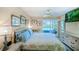 Tranquil bedroom with a cozy queen bed, picturesque views from the balcony, and stylish wicker furniture at 811 Waterside Dr # 102, Venice, FL 34285