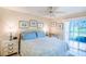 Comfortable bedroom with a queen-size bed, serene decor, and sliding glass doors leading to a private balcony at 811 Waterside Dr # 102, Venice, FL 34285