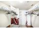 Well-organized walk-in closet with ample storage, shelving, and hanging space for clothes and accessories at 811 Waterside Dr # 102, Venice, FL 34285