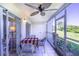 Enclosed lanai with ceiling fan, tiled flooring, and views of lush landscaping at 811 Waterside Dr # 102, Venice, FL 34285