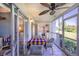 Relaxing lanai with ceiling fan, tiled floors, and views of the backyard and trees at 811 Waterside Dr # 102, Venice, FL 34285