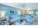 This living room has tile floors, light-colored sofas with patterned pillows, and views of the dining area at 811 Waterside Dr # 102, Venice, FL 34285