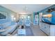 Inviting living room featuring modern furniture, a ceiling fan, and an open floor plan, perfect for relaxation and entertaining at 811 Waterside Dr # 102, Venice, FL 34285