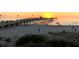 The Venice Fishing Pier at sunset with people strolling along the pier with the sandy beach in the foreground at 811 Waterside Dr # 102, Venice, FL 34285