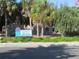 A street view showing the Venice Beach sign surrounded by lush greenery and mature palm trees at 811 Waterside Dr # 102, Venice, FL 34285